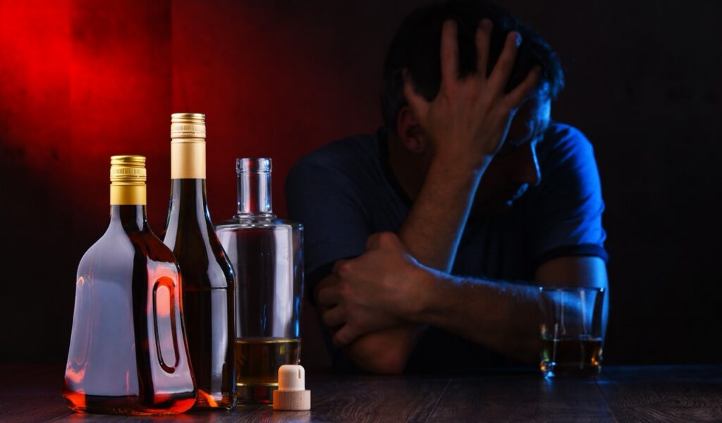 bottles,with,alcoholic,beverages,and,the,figure,of,a,drunk